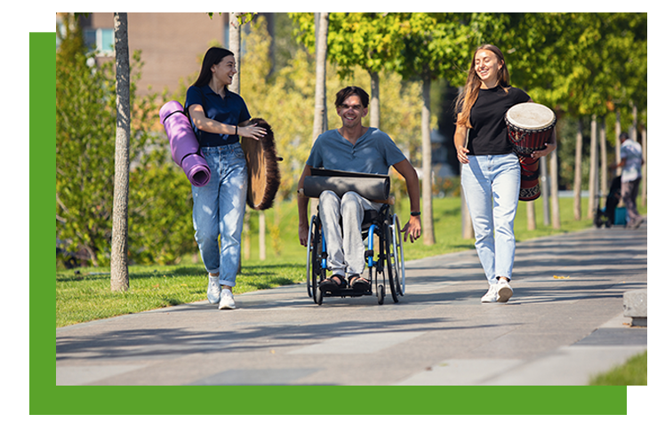 Aparecen 3 personas paseando una de ellas en silla de ruedas